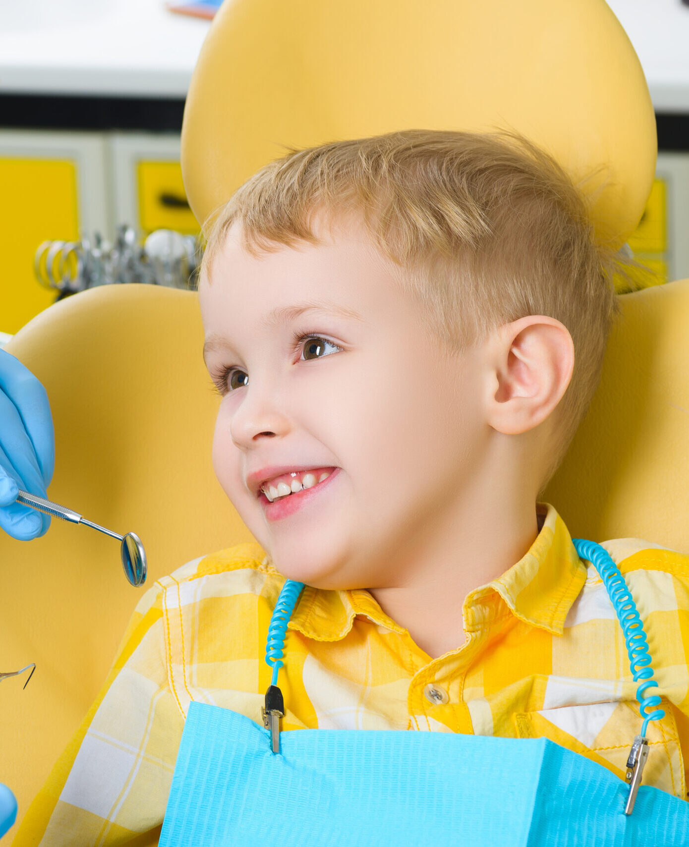 Close up of boy having his teeth examined by a dentist.
