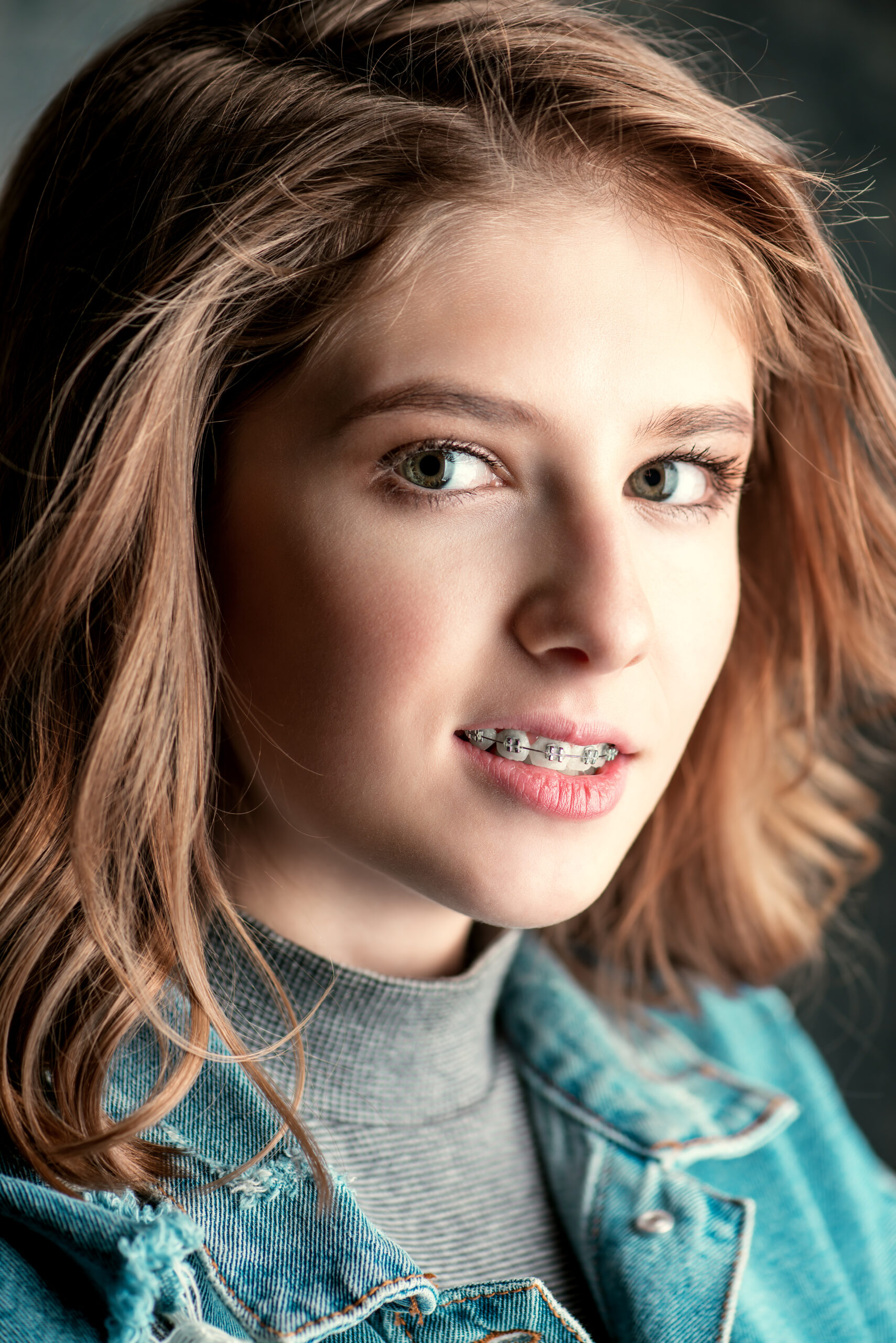 Cute girl teenager wearing dental braces. Healthcare, stomatology and orthodontics.