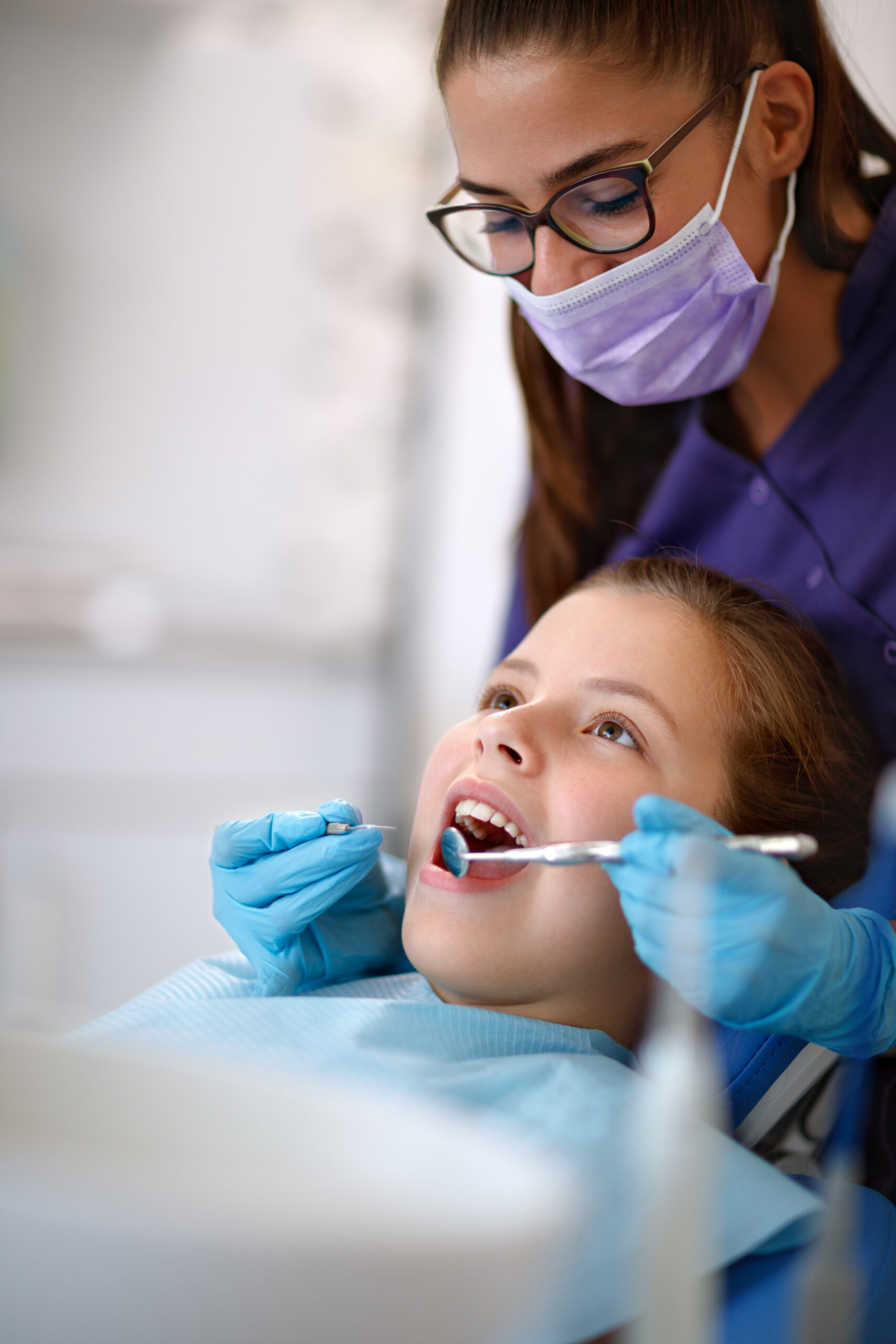 Dentist at work with young female patient in ambulant