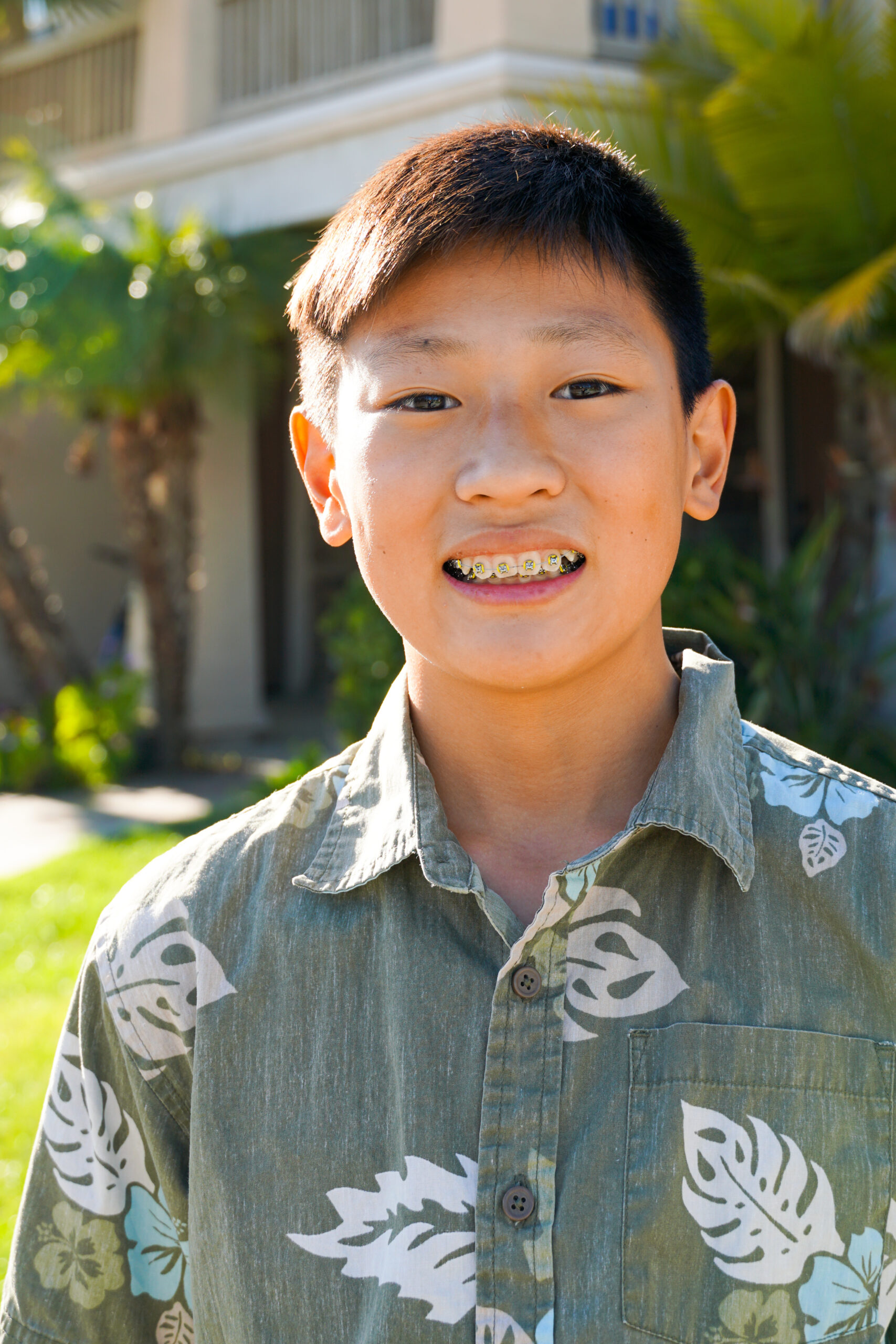 Portrait of young Asian boy with tooth braces. Young teen boy smiling and showing his orthodontic braces on his teeth.