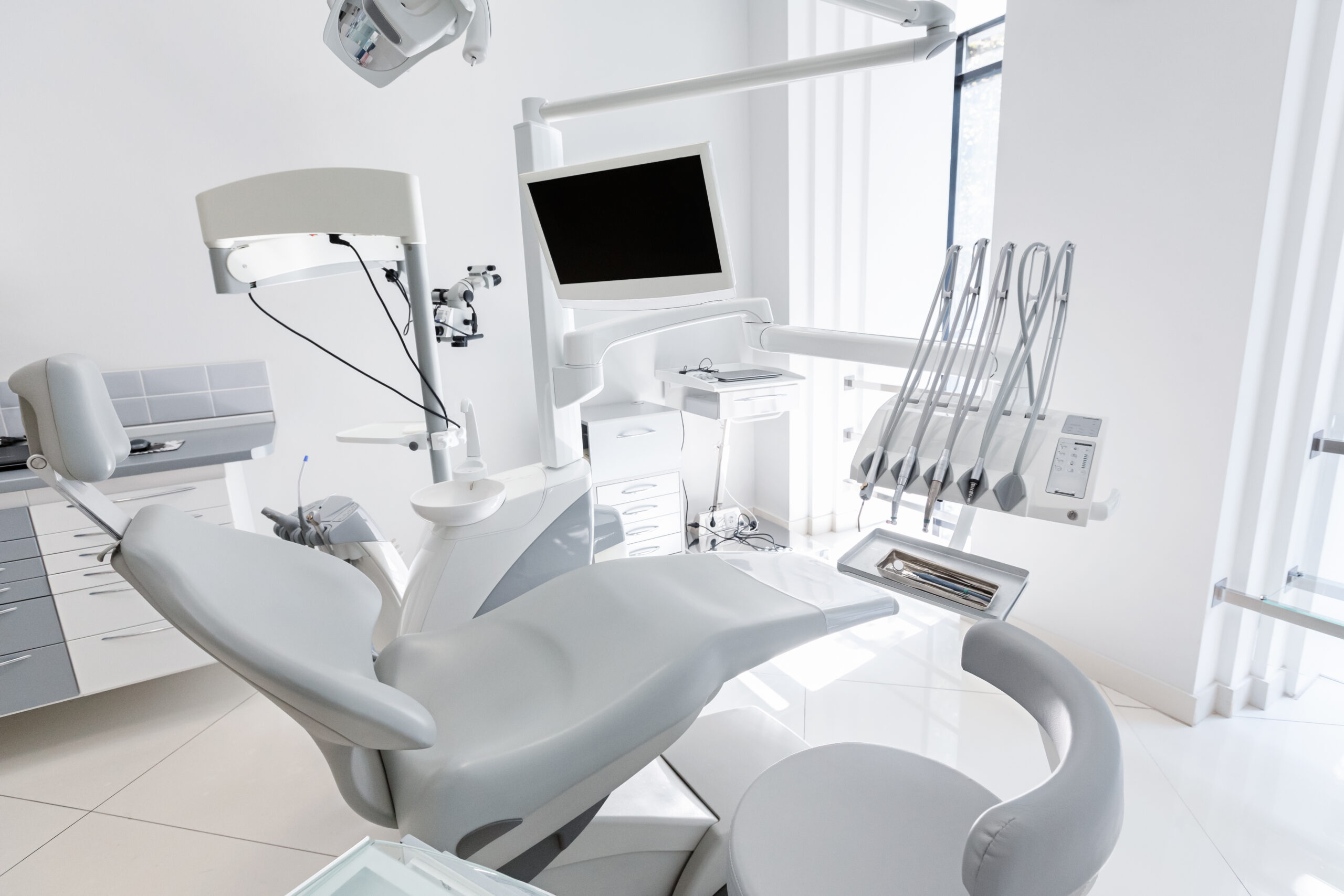 Dentist chair in modern dental clinic. Dentistry, stomatology, medicine medical equipment concept, copy space